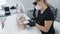 Slow motion cosmetologist makes girl procedure for rejuvenation skin with special device