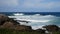 Slow motion of deep blue and teal breaking waves of atlantic ocean with an ocean view