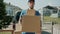 Slow motion of delivery worker unloading van and carrying boxes in house