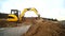 Slow motion of a digger digging a pit and throwing dirt. Close-up of a excavator bucket that throws out the earth. Shot