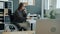 Slow motion of disabled businesswoman in wheelchair making mobile phone call in office