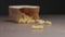 Slow motion dry organic bronze cut fusilli spill out from paper bag on walnut table