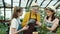 Slow motion of elderly lady experienced farmer discussing plants with daughter and granddaughter