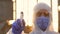 SLOW MOTION, epidemiologist wearing a face mask and protective suit sprays a disinfectant spray during the COVID19