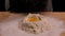 Slow motion of falling egg into flour pile. Egg dropping into flour. Food blog, flour and bakery products. Process of