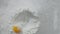 Slow motion of falling eggs into flour stock. Footage food. Egg dropping into flour, slow motion. Yolk Falls Into the