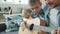 Slow motion of father and son playing the guitar, child learning to use musical instrument