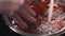 Slow motion of female teen hands washing cherry tomatoes in bowl closeup