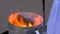 Slow motion: fire, flame and burning wood in portable metal tube oven - close up