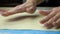 Slow motion footage. Baker hand smoothes the dough