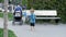 Slow motion footage of cute barefoot toddler boy running on playground with toy shovel and bucket