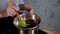 Slow motion footage of a melting chocolate process. Beautiful, cheerful confectioner mixing chocolate in a bowl with