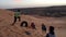 Slow motion footage of Tuareg children who are playing on dunes of Algerian Sahara