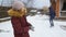 Slow motion footage of two girls having snow ball fight