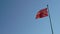 Slow motion footage of Waving Turkish flag on a blue sky