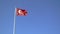 Slow motion footage of Waving Turkish flag on a blue sky