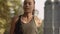 Slow motion FullHD girl in the headphones. A sports girl is jogging in the early morning. Athletic attractive girl