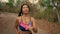 Slow motion gimbal tracking on young attractive and exotic Asian Indonesian runner woman in jogging workout outdoors at rural road