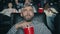 Slow motion of grey-haired man chewing popcorn watching scary movie in cinema