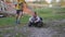 Slow motion group of children playing, running and riding on toy vehicle outdoor