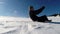 Slow motion of a guy turn a somersault in the snow. Tumbling man having fun