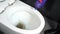 Slow-motion of hand cleaning toilet bowl with a detergent