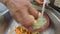 Slow motion of hands washing vegetables in the kitchen sink