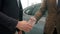 Slow motion of handshake, male customer buying car in showroom taking keys
