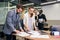 Slow motion of handsome enterprising bearded businessman standing near boardroom table with his attentive female