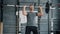 Slow motion of handsome young sportsman lifting barbell training in gym alone