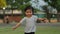 Slow-motion of happy toddler girl running on grass field in park