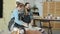 Slow motion of happy young couple having fun in pottery workshop enjoying leisure time