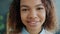 Slow motion headshot of attractive Afro-American teenager smiling at home