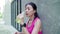 Slow motion - Healthy beautiful young Asian runner woman drinking water because feel tired after running on street.