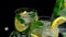 Slow motion Ice cube fall splash drops. Mojito refreshing cocktail, alcohol drink. Lemonade with lemon and mint leaves