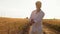 Slow Motion, Indian Man in Glasses and White Shirt Stand on Road Near Wheat Field and Roll Up Sleeves on Shirt