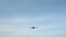 Slow motion of jet plane approaching landing across blue sky