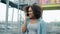 Slow motion of joyful African American teenager talking on mobile phone outdoors