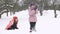 Slow motion of joyful kids playing in snow. Two happy girls having fun outside winter day