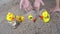 Slow motion kid play sand with yellow rubber duck toy