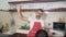 SLOW MOTION kitchen rock star - young cool attractive man in apron singing and dancing happy holding cooking pan as playing guitar