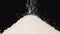SLOW MOTION: Macro shot of falling of granulated sugar on a heap