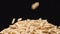 SLOW MOTION: Macro shot of falling of oats on a heap