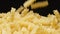SLOW MOTION: Macro shot of falling of spiral pasta on a heap