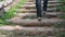 Slow motion. Male Hiker walking up the wooden stairs in the forest.