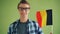 Slow motion of male student patriot holding flag of Germany and smiling