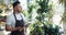 Slow motion of man flower store owner using tablet at work touching screen