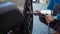 Slow-motion of mechanic man using an electric drill to tightening the bolts of vehicle wheel for install a car tire