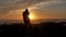Slow motion men warrior dancer practicing silhouette tai chi karate kung Fu on the rocky stones horizon at sunset or