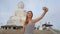 Slow motion model young woman taking selfies on smartphone near Buddha s statue in Thailand.